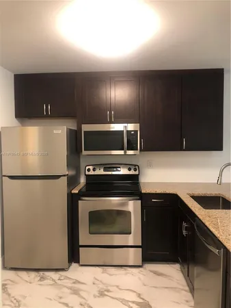 a kitchen with a sink and a refrigerator