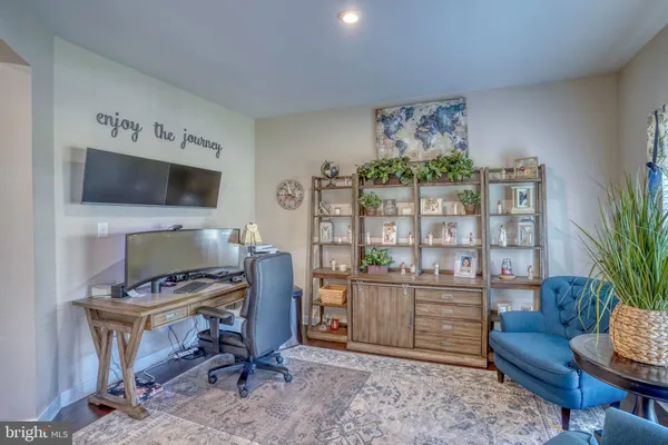 a living room with lots of furniture and a view of kitchen