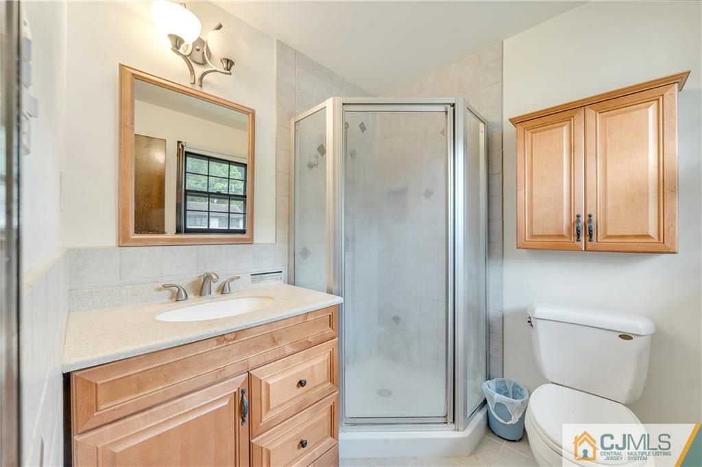 65 Dellwood Road Edison, NJ 08820 - Photo 16 of 24 a bathroom with a sink a toilet and shower