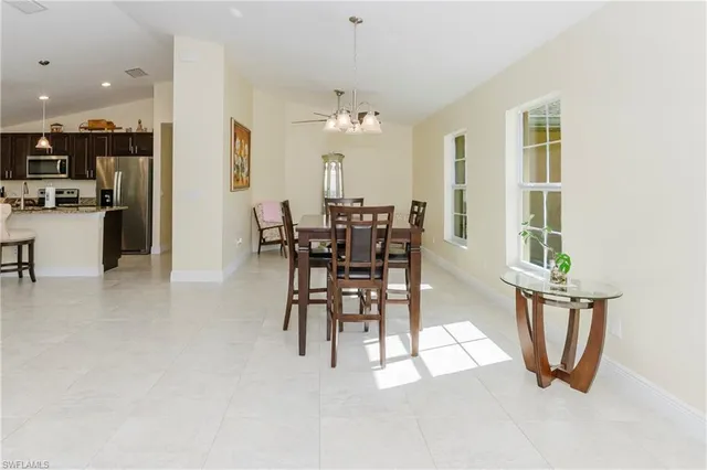 a view of a dining room with furniture and chandelier