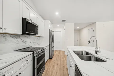 a kitchen with a sink stove and microwave