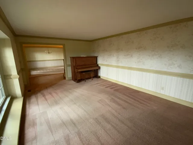 a view of an empty room and a window