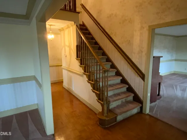 a view of an empty room with a fireplace and a window