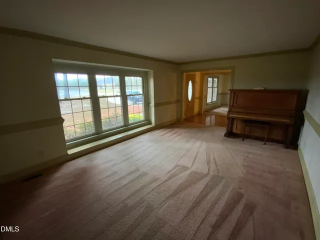 a view of an empty room with a chandelier