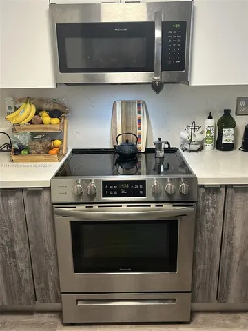 a stove top oven sitting inside of a kitchen