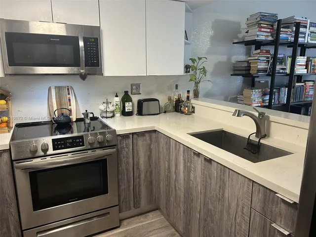 a kitchen with a stove and a microwave