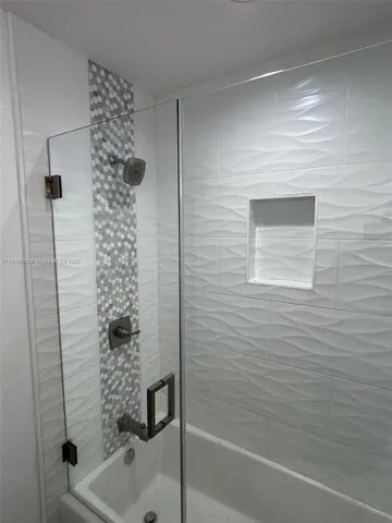 a bathroom with a shower and a sink