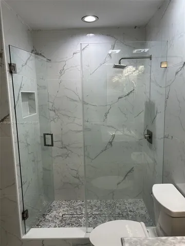 a bathroom with a shower and toilet