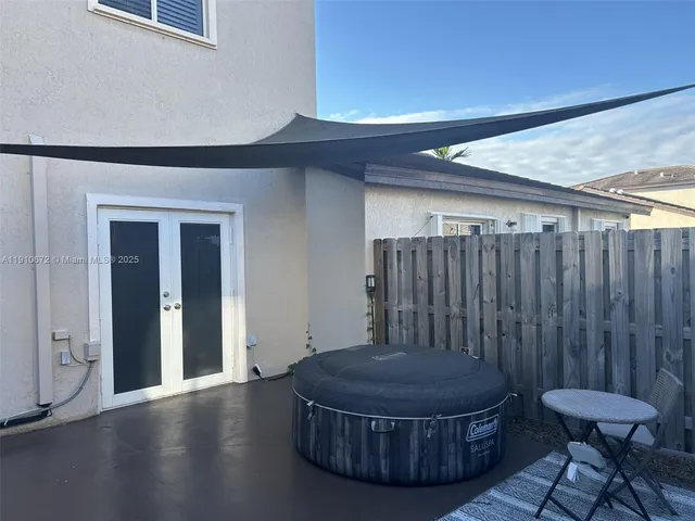 a view of a hallway with furniture and wooden floor