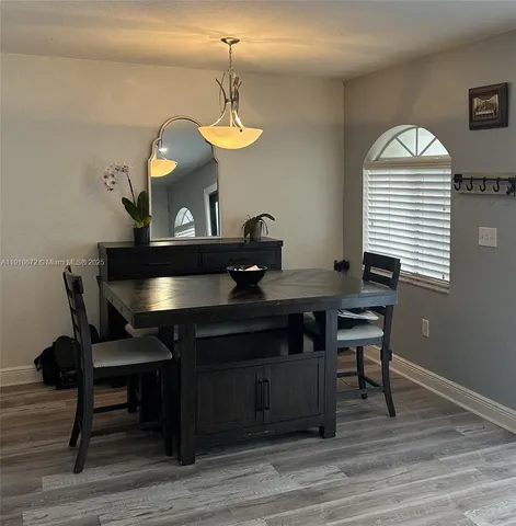 a view of a dining room with furniture and wooden floor