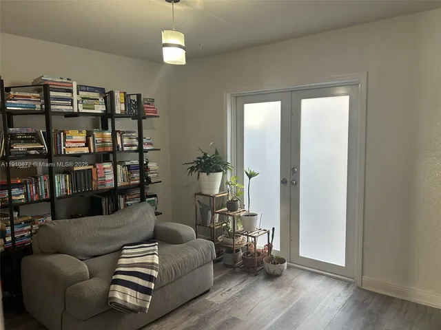 a living room with furniture a ceiling fan and a window
