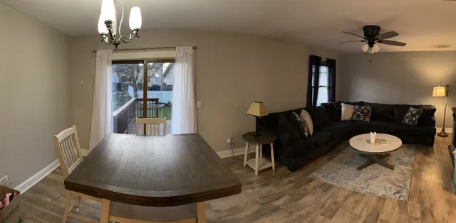 a living room with furniture and a chandelier