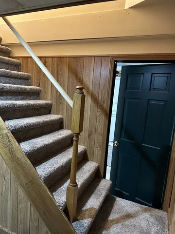 a view of staircase with white walls and a window