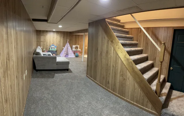 a living room with furniture and stairs