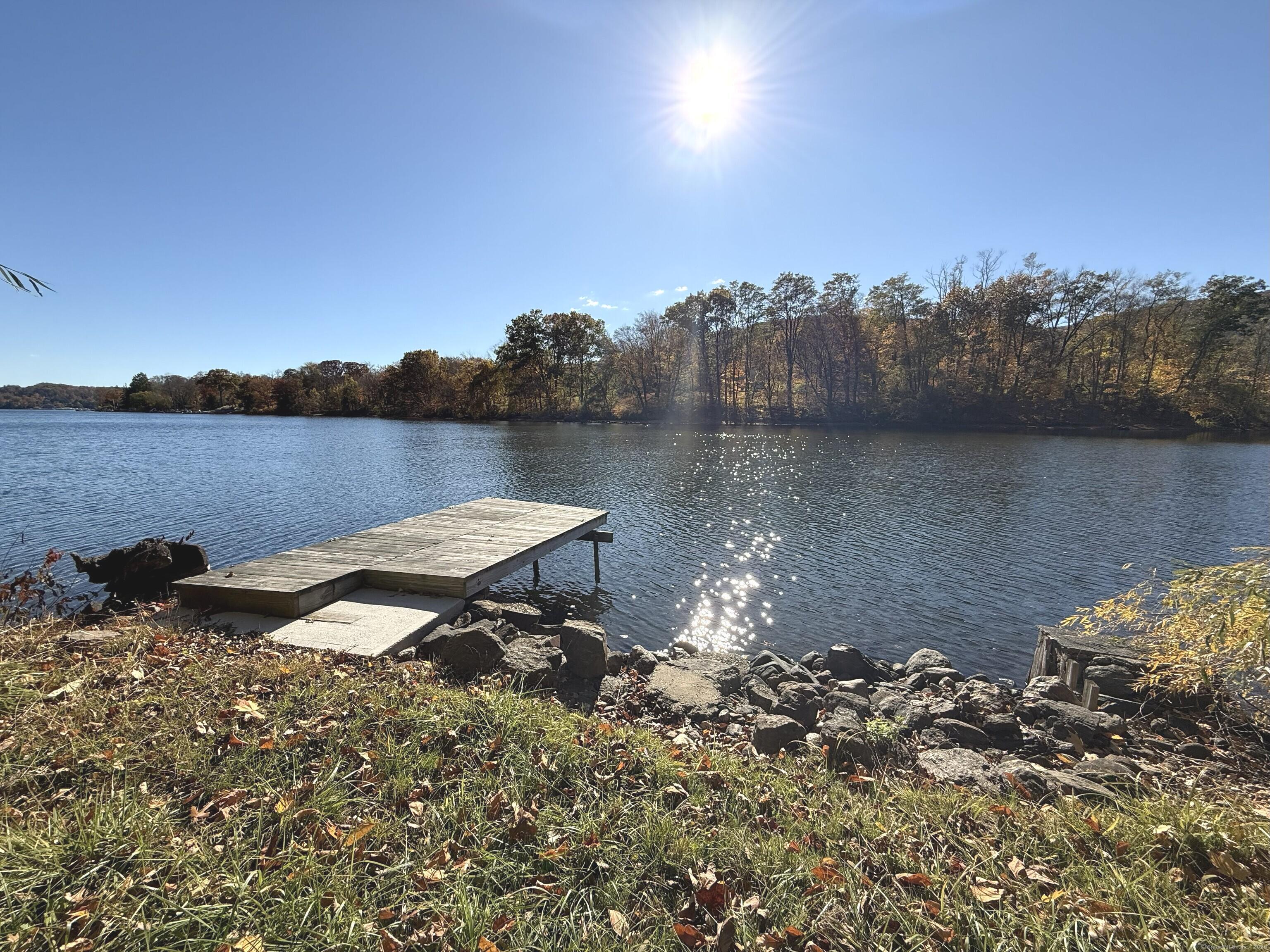 11 Bogus Hill Road New Fairfield, CT 06812 - Photo 1 of 13 a view of a lake with a mountain in the background