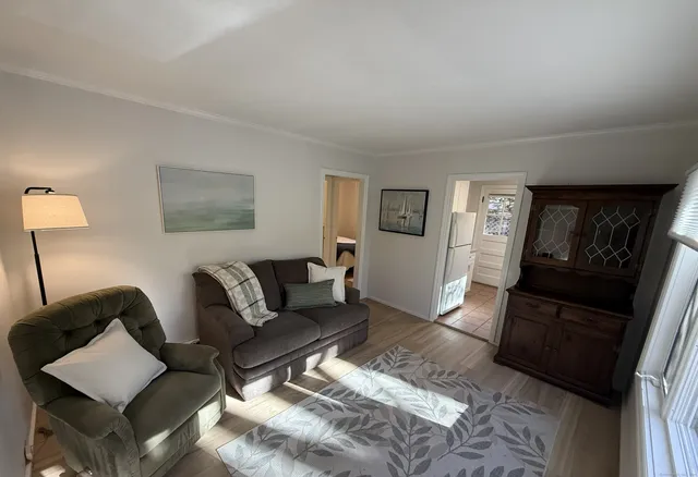 a living room with furniture and a mirror