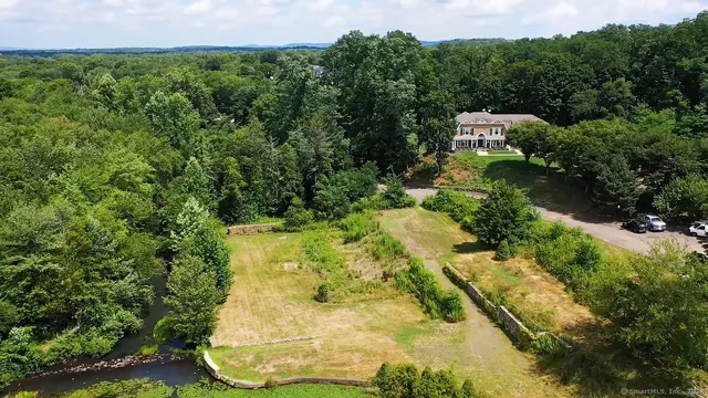 an aerial view of a residential houses with yard
