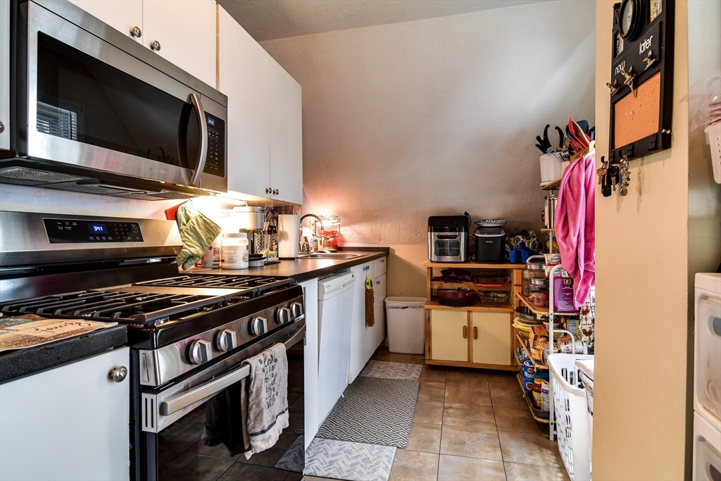 30 Winter Street Framingham, MA 01702 - Photo 16 of 23 a kitchen with a stove and a microwave