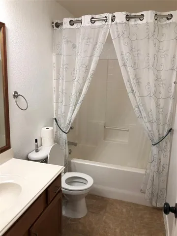 a bathroom with a toilet sink and shower