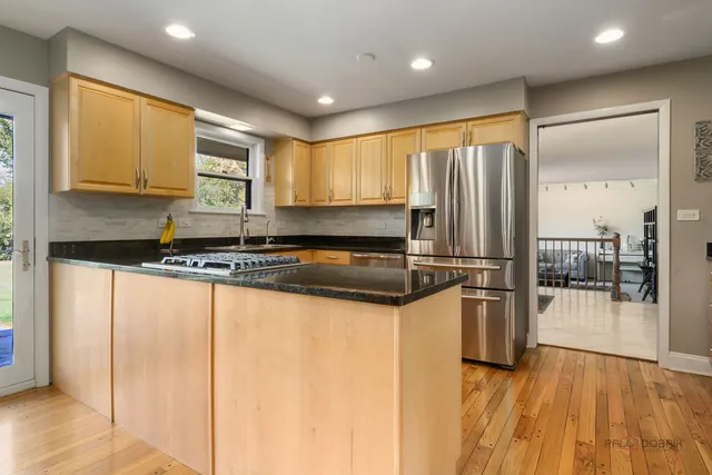 a bathroom with a granite countertop toilet sink and mirror