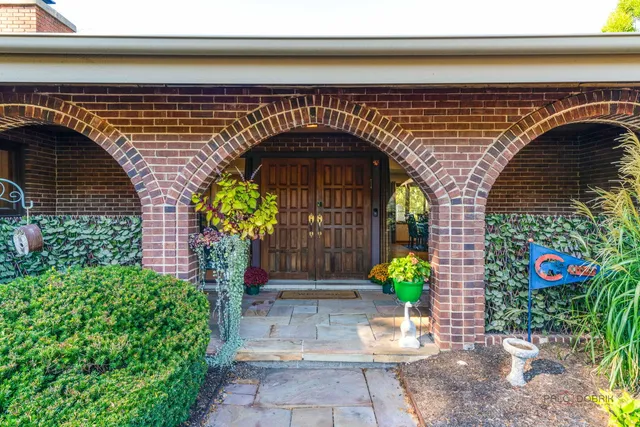 a view of a patio with couple of chairs and potted plants