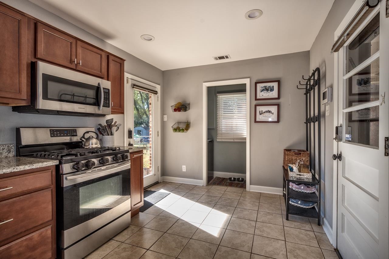5135 Princeton Road Memphis, TN 38117 - Photo 11 of 24 a kitchen with stainless steel appliances granite countertop a stove and a refrigerator