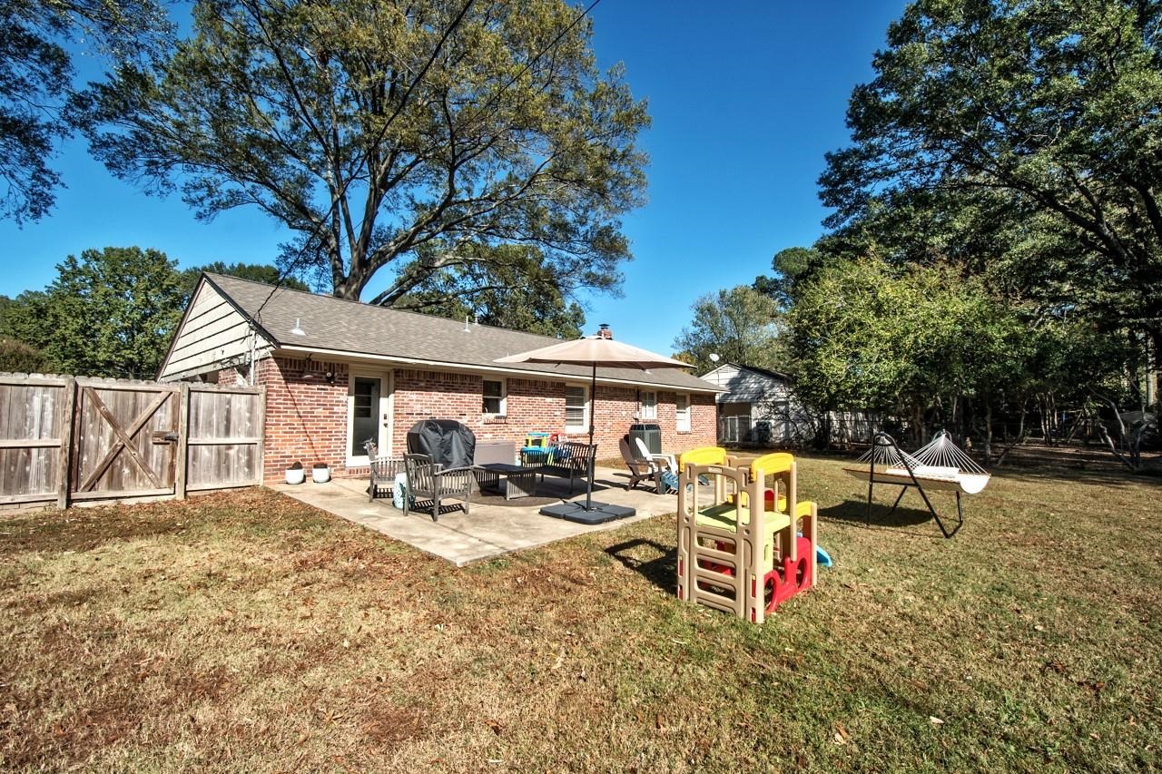 5135 Princeton Road Memphis, TN 38117 - Photo 21 of 24 a view of patio with a table and chairs under an umbrella