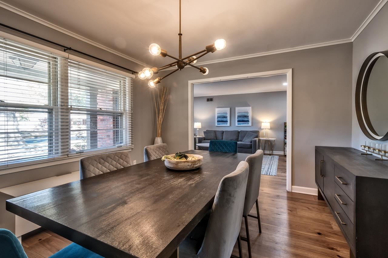 5135 Princeton Road Memphis, TN 38117 - Photo 9 of 24 a dining room with furniture a chandelier and wooden floor