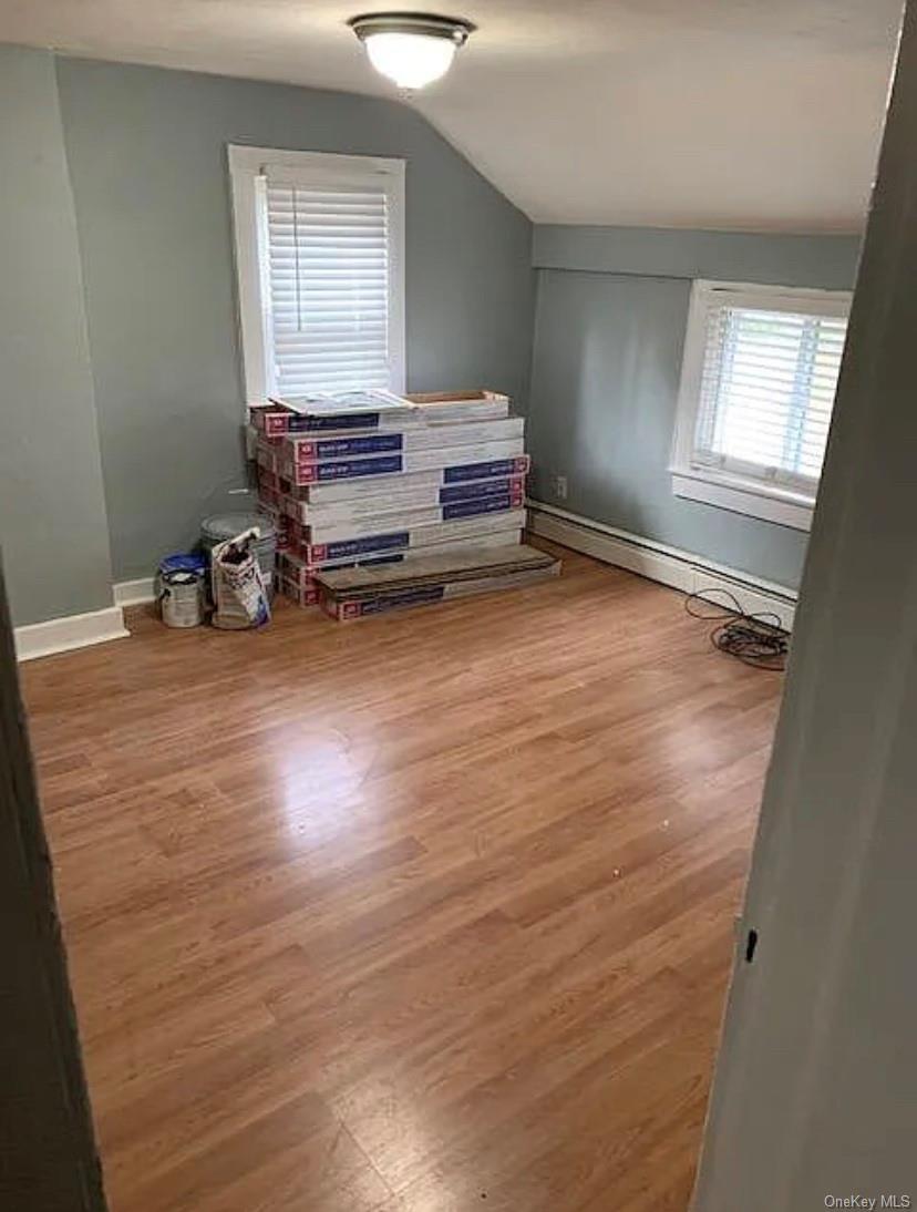 331 Angola Road, Unit 7 Cornwall, NY 12518 - Photo 7 of 7 Room featuring wood-finish flooring, two windows with white blinds, and a dome ceiling light fixture