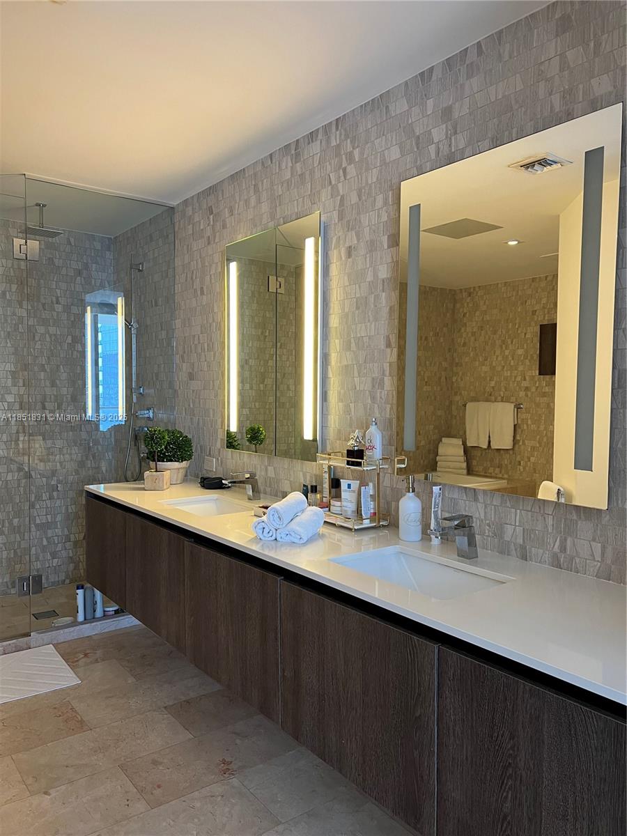 88 Southwest 7th Street, Unit 3007 Miami, FL 33130 - Photo 11 of 36 a bathroom with a double vanity sink mirror and double