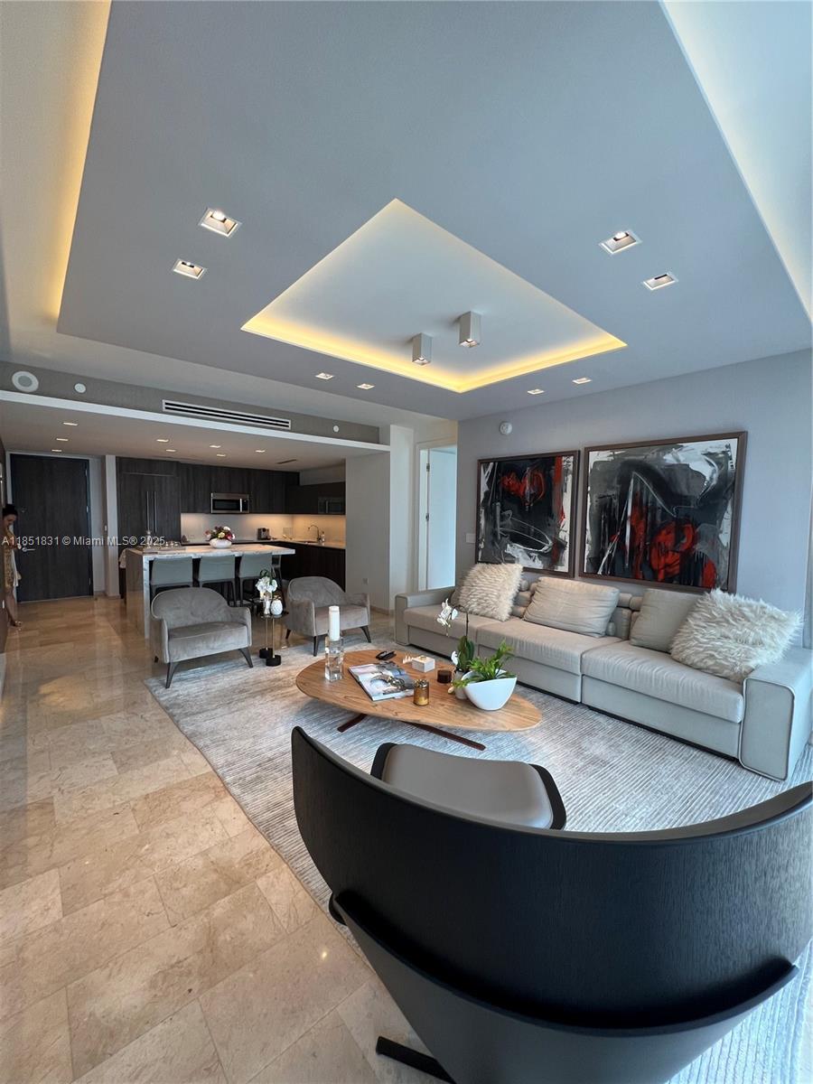 88 Southwest 7th Street, Unit 3007 Miami, FL 33130 - Photo 2 of 36 a living room with furniture and a table