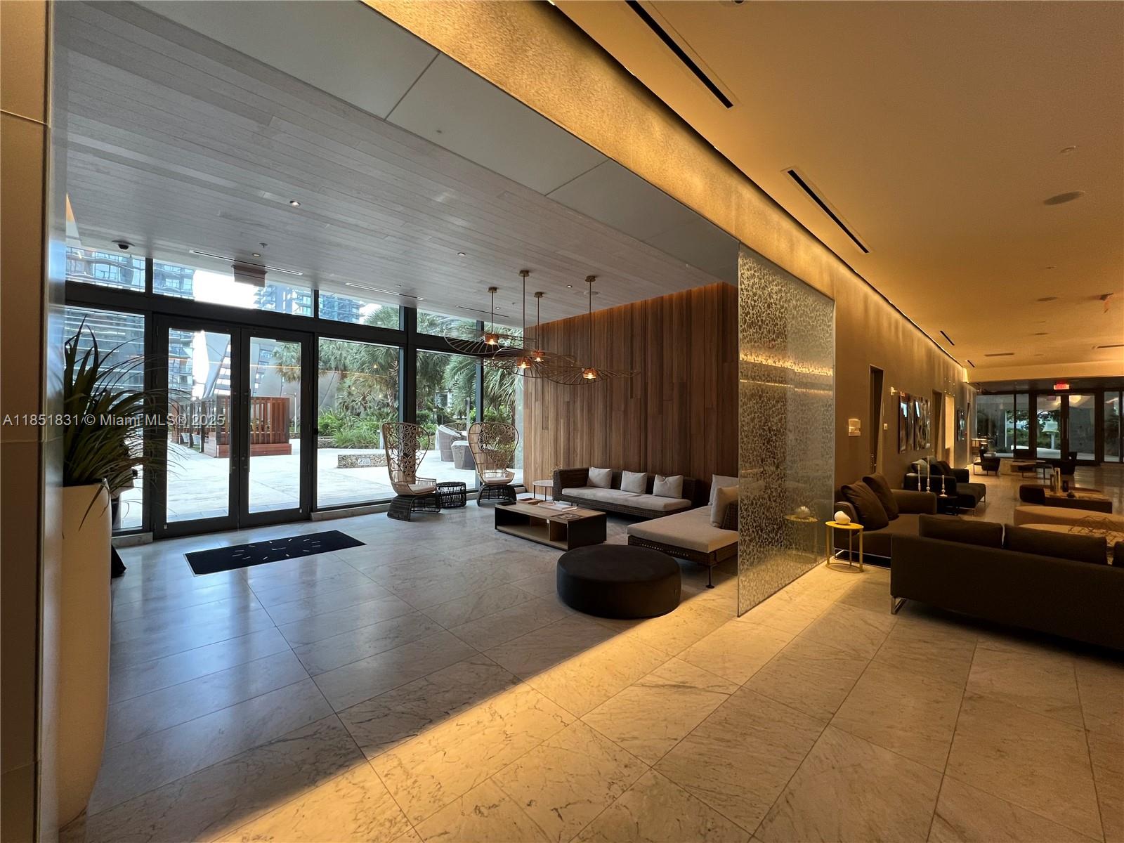 88 Southwest 7th Street, Unit 3007 Miami, FL 33130 - Photo 22 of 36 a living room with patio furniture and floor to ceiling windows