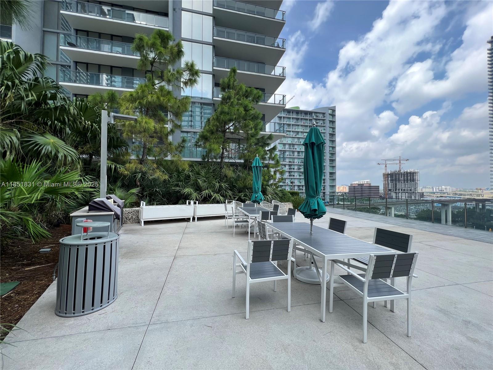 88 Southwest 7th Street, Unit 3007 Miami, FL 33130 - Photo 23 of 36 a view of a patio with couches table and chairs and potted plants