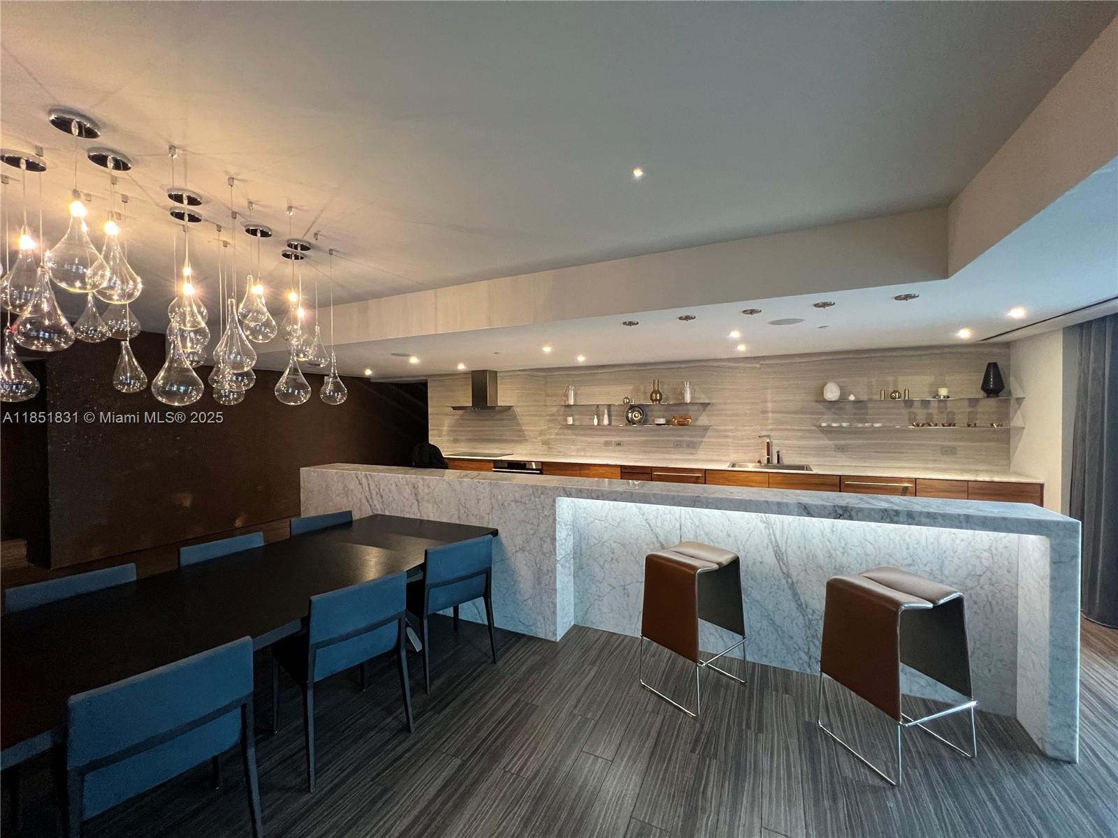 88 Southwest 7th Street, Unit 3007 Miami, FL 33130 - Photo 32 of 36 a kitchen with a table chairs and wooden floor