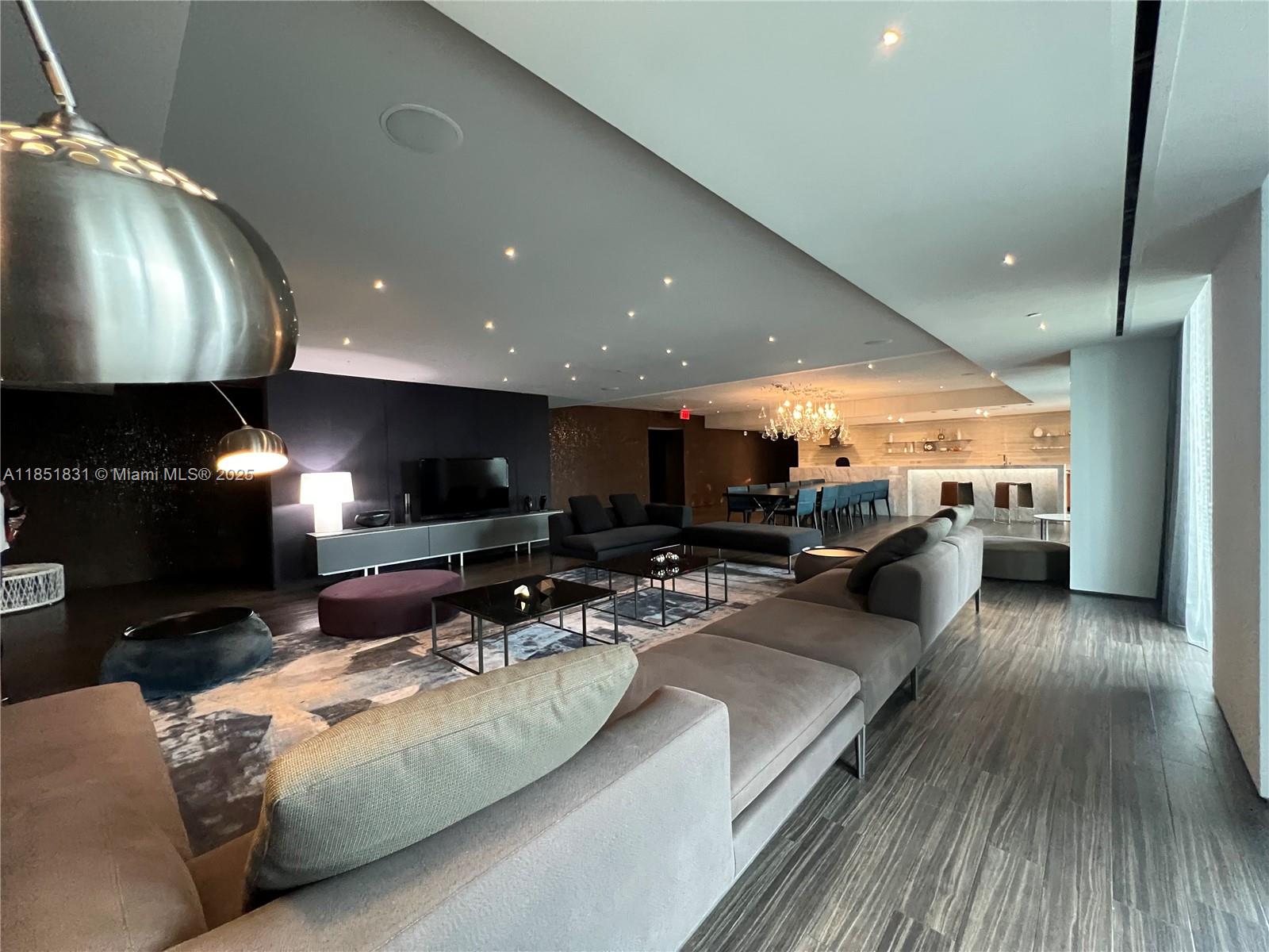 88 Southwest 7th Street, Unit 3007 Miami, FL 33130 - Photo 34 of 36 a living room with furniture and a flat screen tv