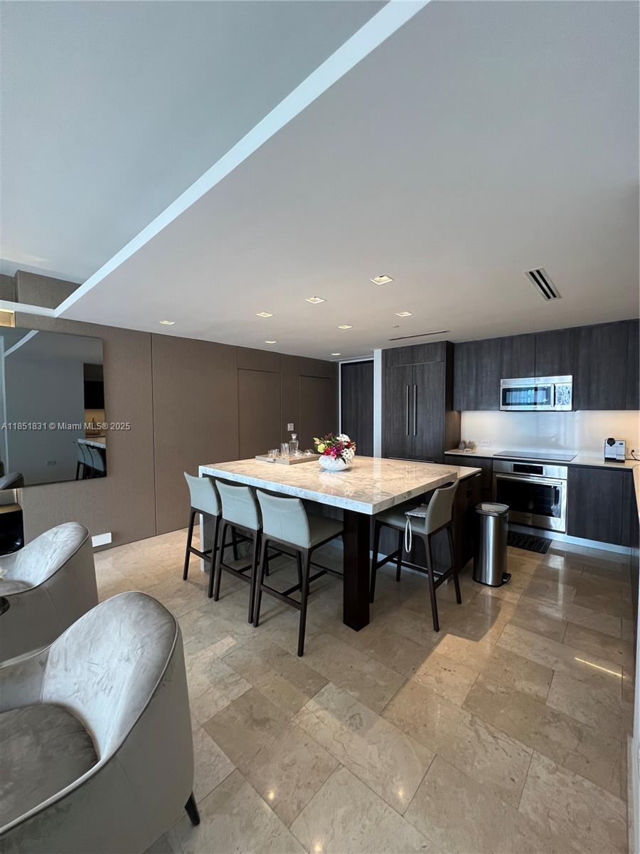 88 Southwest 7th Street, Unit 3007 Miami, FL 33130 - Photo 6 of 36 a view of a dining room with furniture