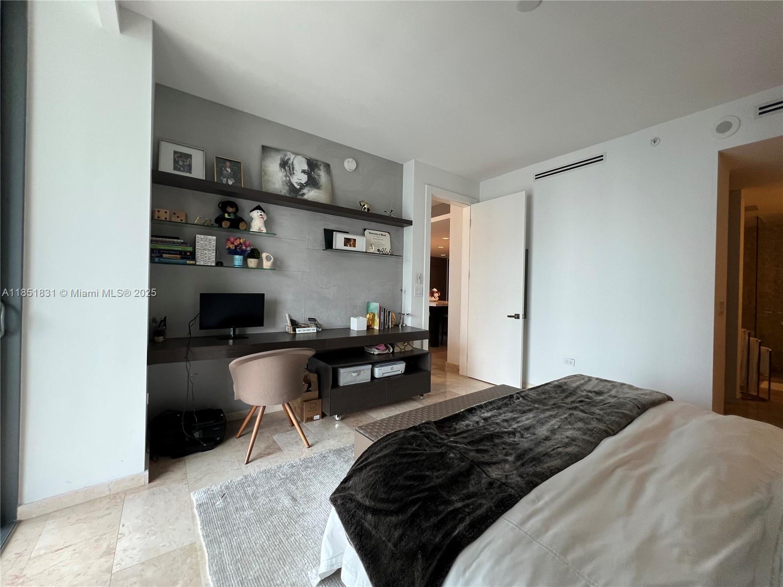 88 Southwest 7th Street, Unit 3007 Miami, FL 33130 - Photo 9 of 36 a bedroom with a bed a computer on desk and a stool