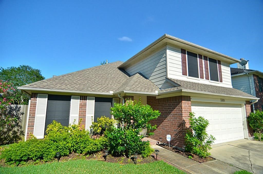 16915 Lighthouse View Drive Friendswood, TX 77546 - Photo 2 of 44 a front view of a house with garden