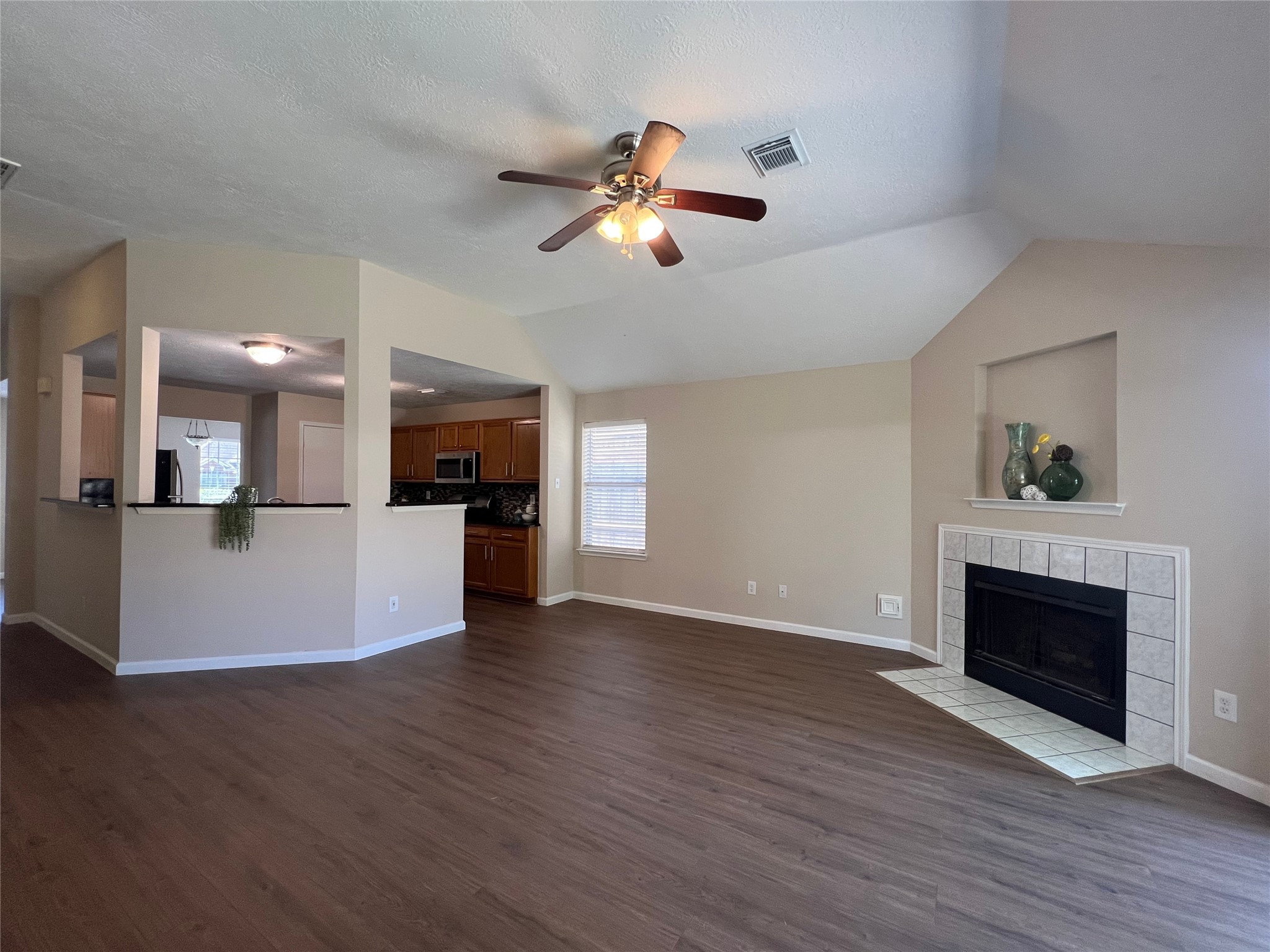 16915 Lighthouse View Drive Friendswood, TX 77546 - Photo 9 of 44 a view of a livingroom with fireplace wooden floor and a ceiling fan