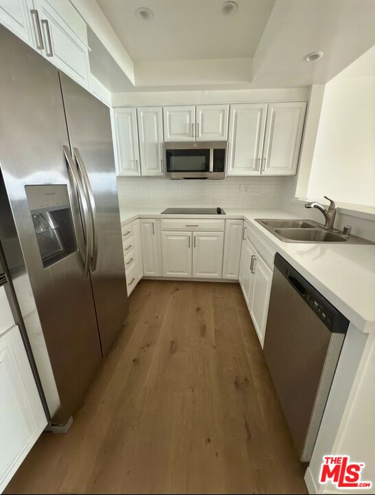 18069 Coastline Drive, Unit 9 Malibu, CA 90265 - Photo 7 of 22 a kitchen with granite countertop a refrigerator sink and microwave
