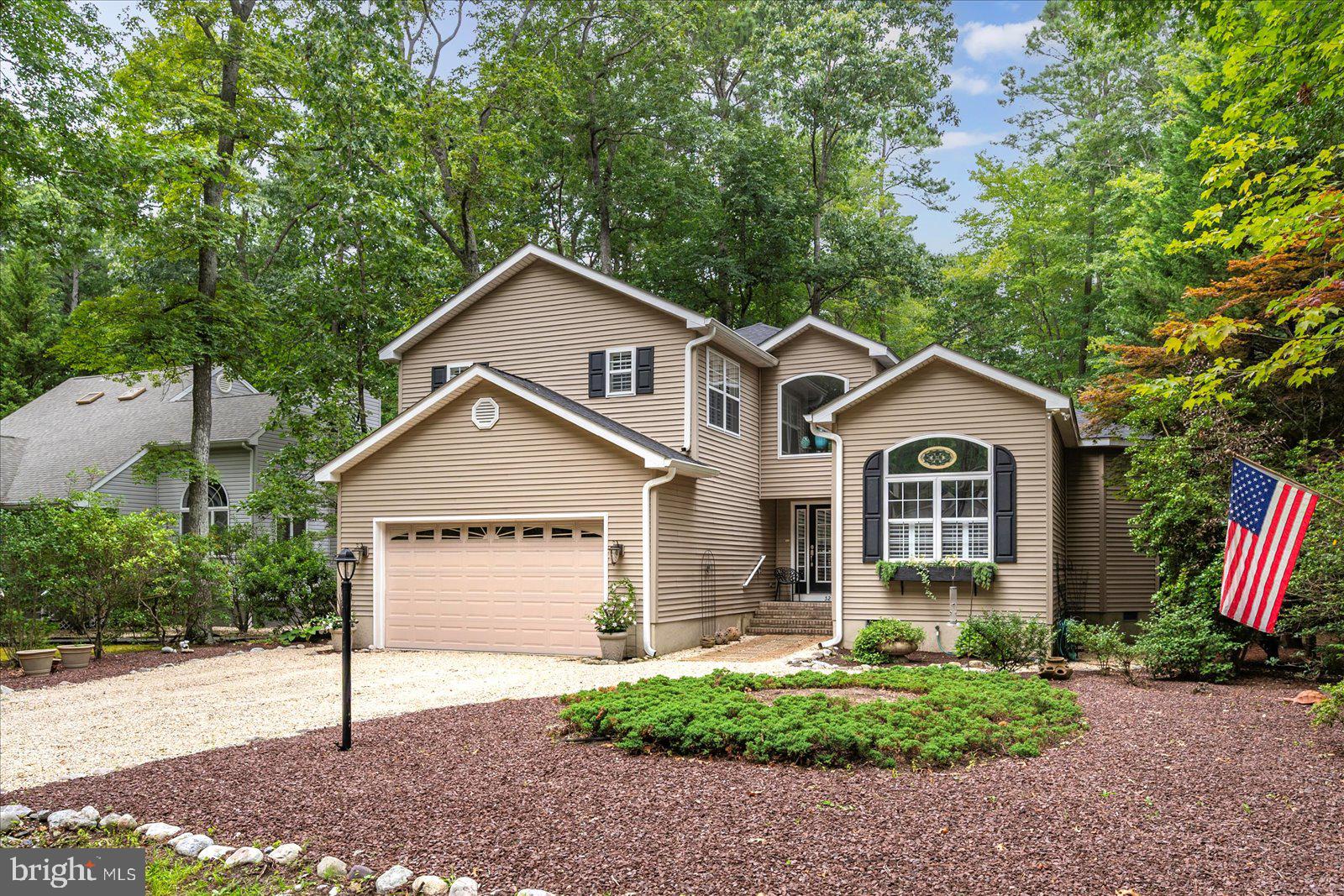 52 Sandyhook Road Ocean Pines, MD 21811 - Photo 2 of 131 a front view of a house with a yard and garage