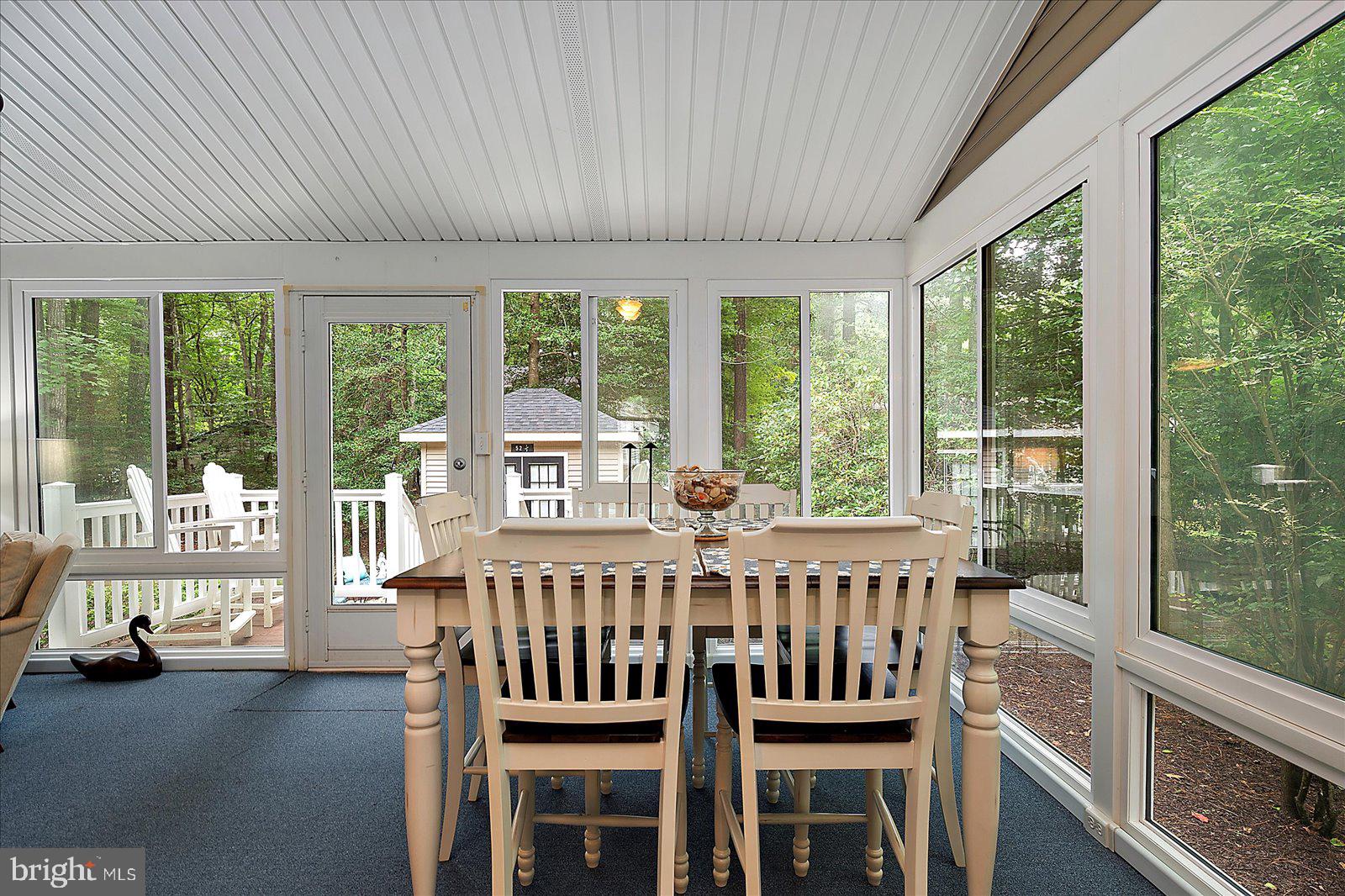 52 Sandyhook Road Ocean Pines, MD 21811 - Photo 32 of 131 a view of a dining room with furniture large windows and wooden floor
