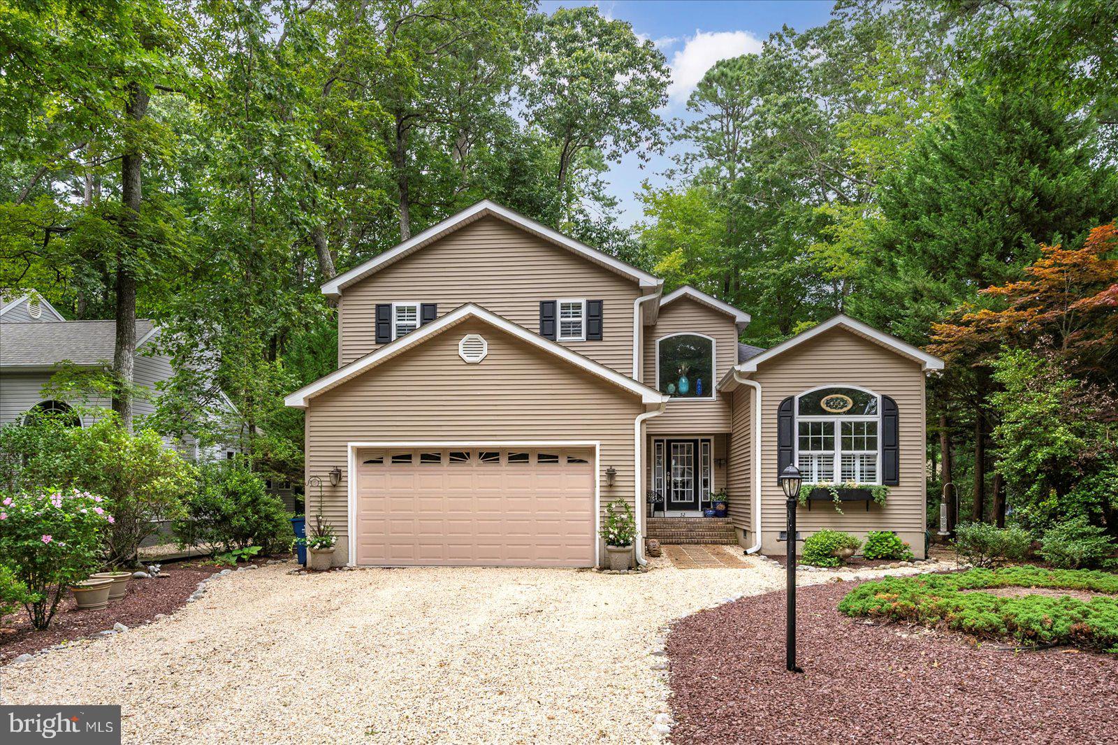 52 Sandyhook Road Ocean Pines, MD 21811 - Photo 77 of 131 a front view of a house with a yard and garage