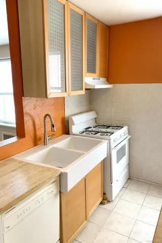 a kitchen with a stove a sink and a microwave