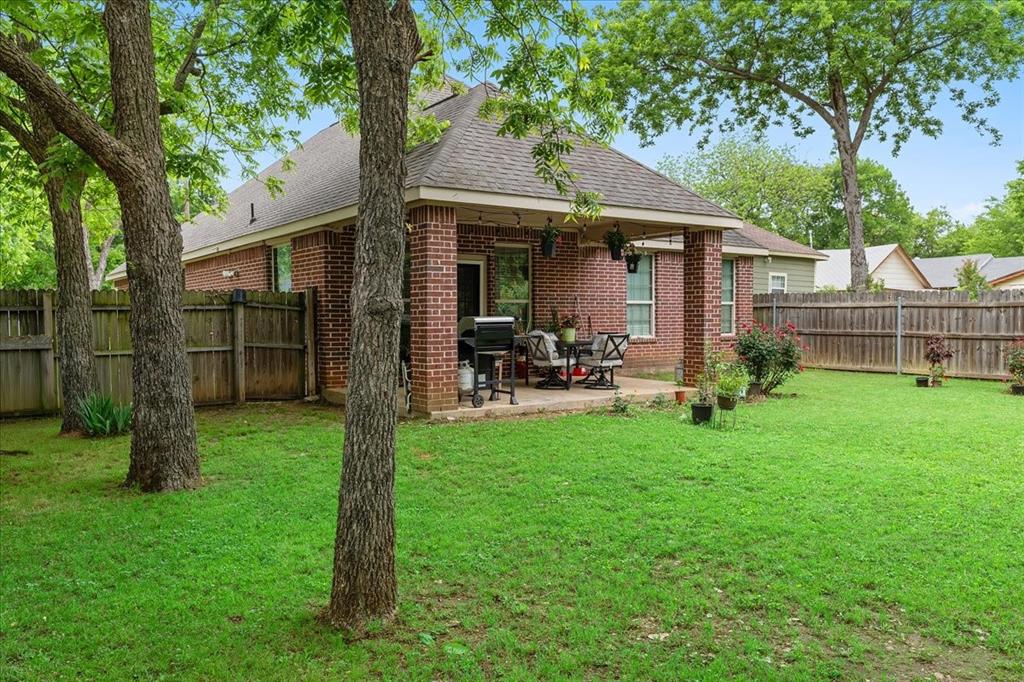 502 Ritchey Street Gainesville, TX 76240 - Photo 28 of 29 a view of a chair and table in backyard of the house