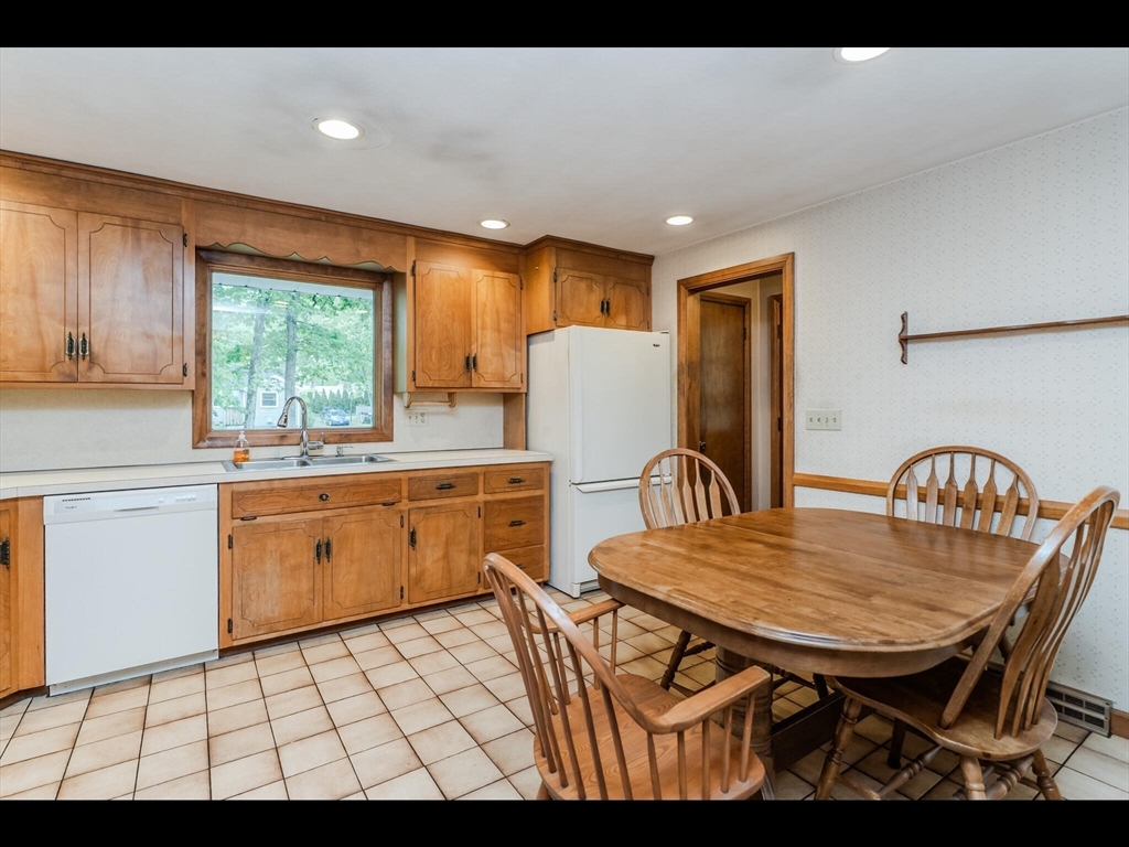 557 Maple Road Longmeadow, MA 01106 - Photo 15 of 31 a kitchen with a table chairs appliances and windows