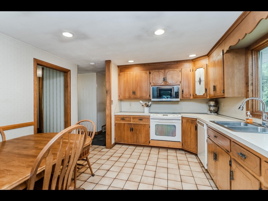 557 Maple Road Longmeadow, MA 01106 - Photo 16 of 31 a kitchen with stainless steel appliances granite countertop a sink and cabinets
