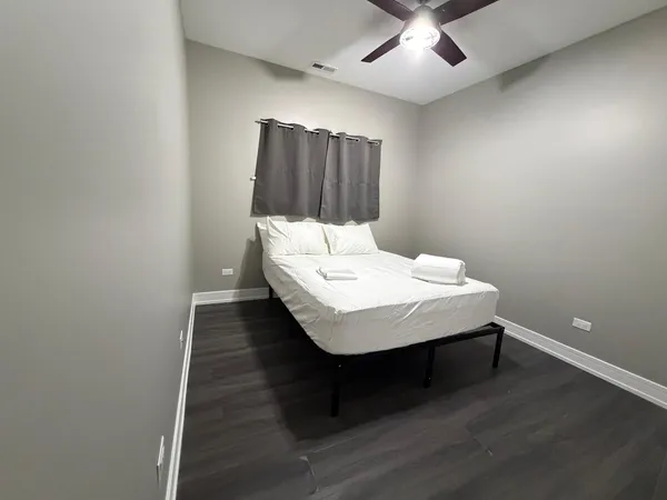 a room with a table and ceiling fan