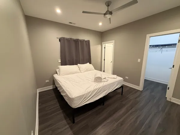 a bedroom with a bed and wooden floor