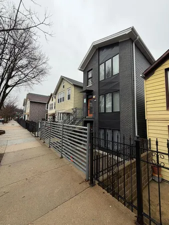 a view of a brick house with large windows